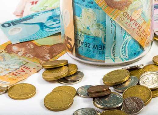 Accounting - New Zealand notes and coins on a desk